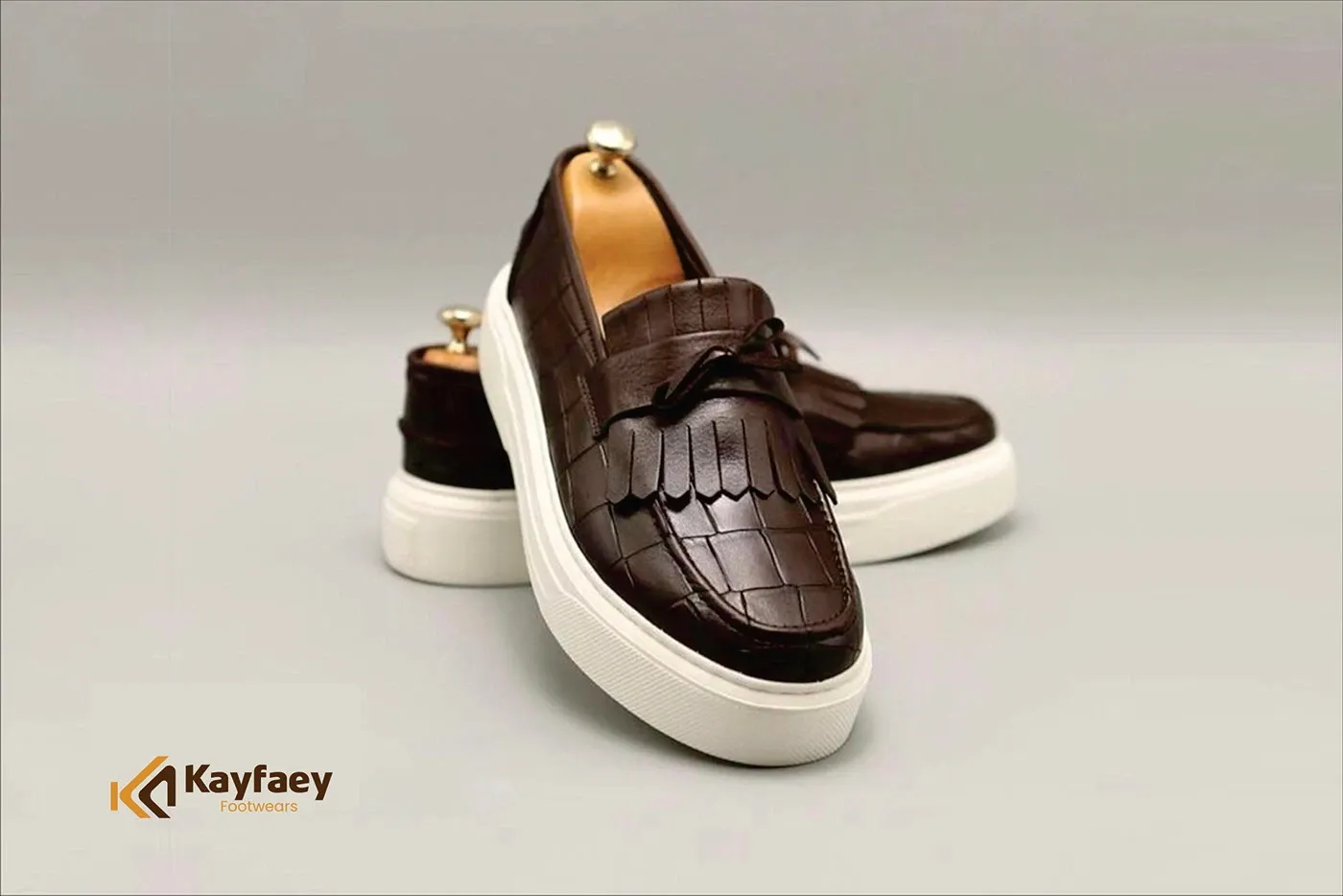 A pair of handmade loafers photographed against a neutral backdrop