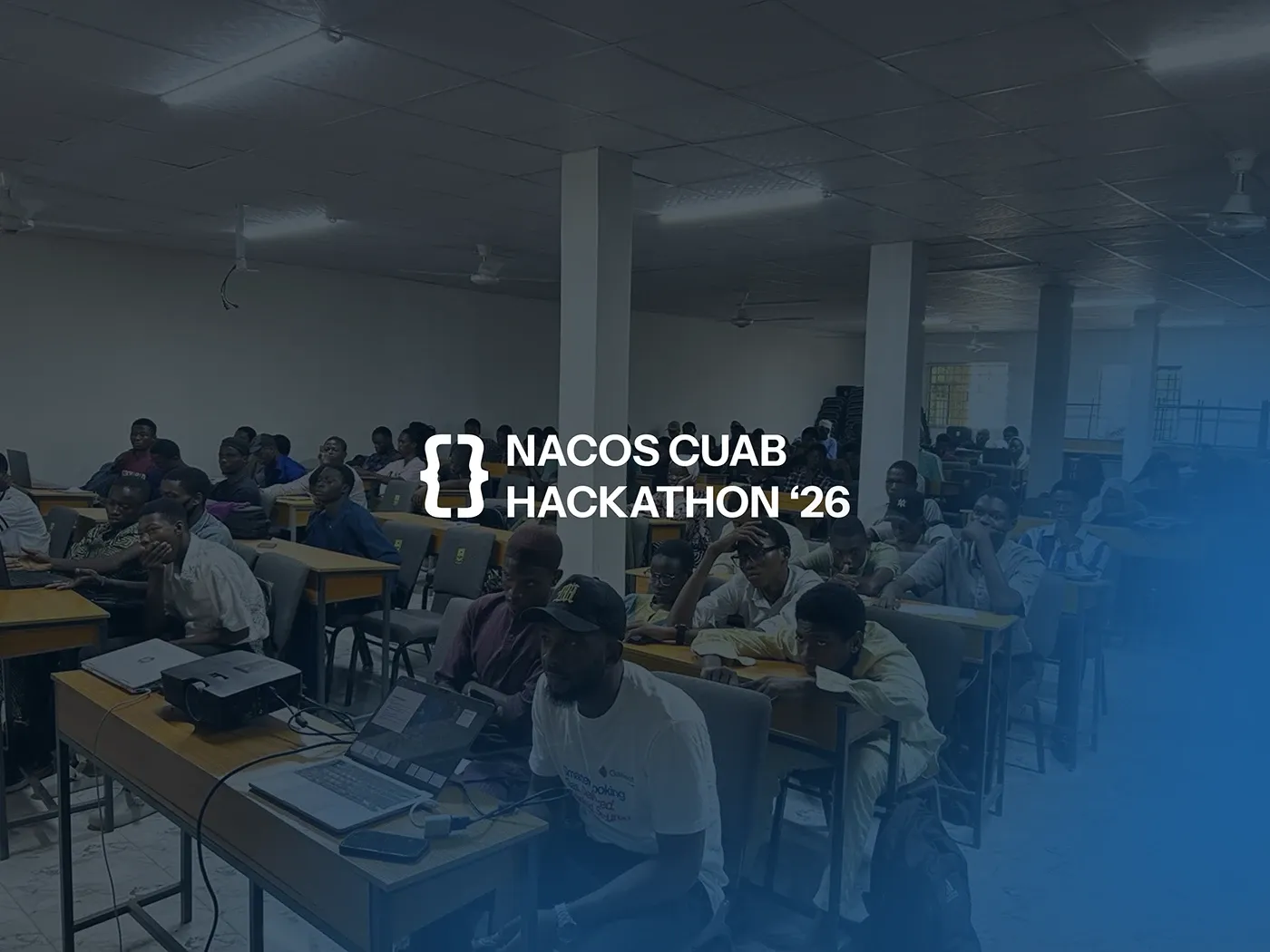 The hall during the hackathon, teams working at long tables
