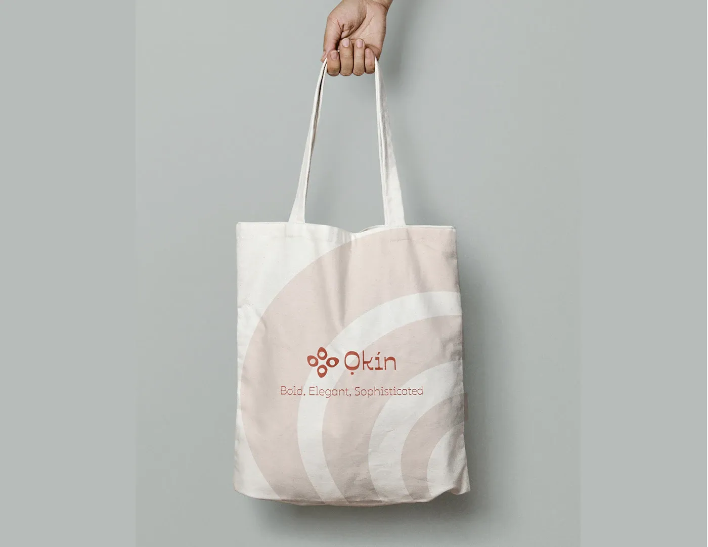 A canvas tote carrying the mark and tagline